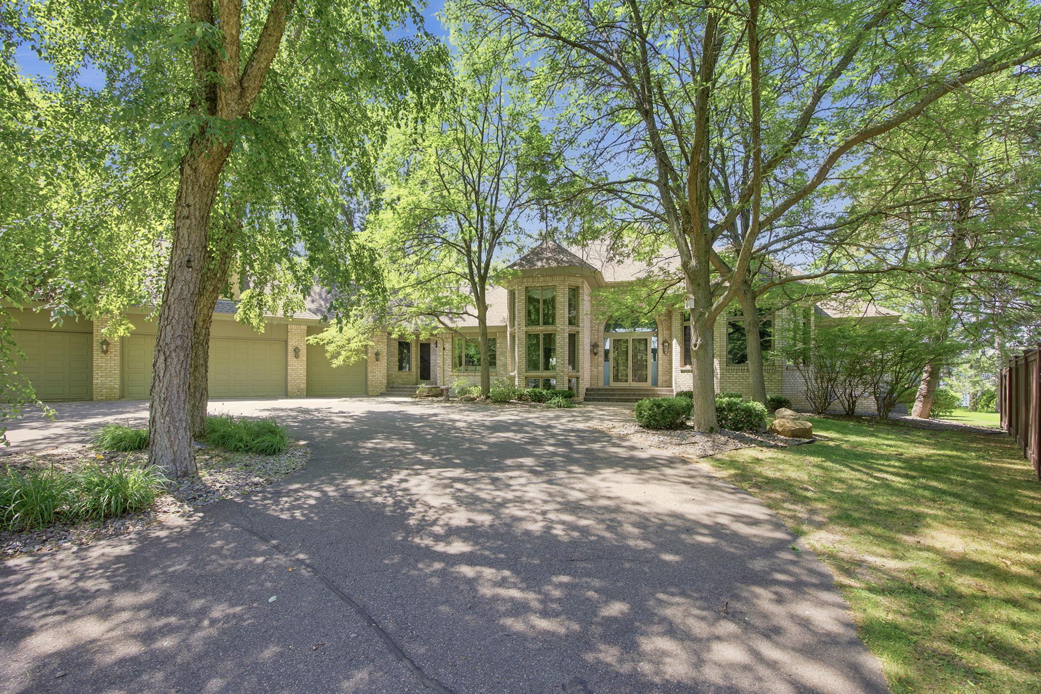 A broad wraparound driveway and generous garage approach create an impressive arrival beneath a canopy of trees
Enjoy a spacous wraparound driveway