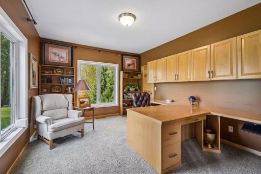 Main level office space off the entryway with built in organizational components and closet
