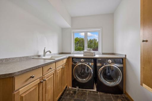 Main floor laundry room with a sink
