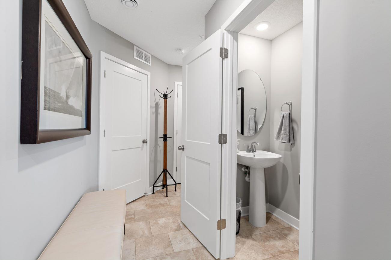 (Photo of a decorated model, actual homes finishes will vary) Conveniently located powder bath on the main level.