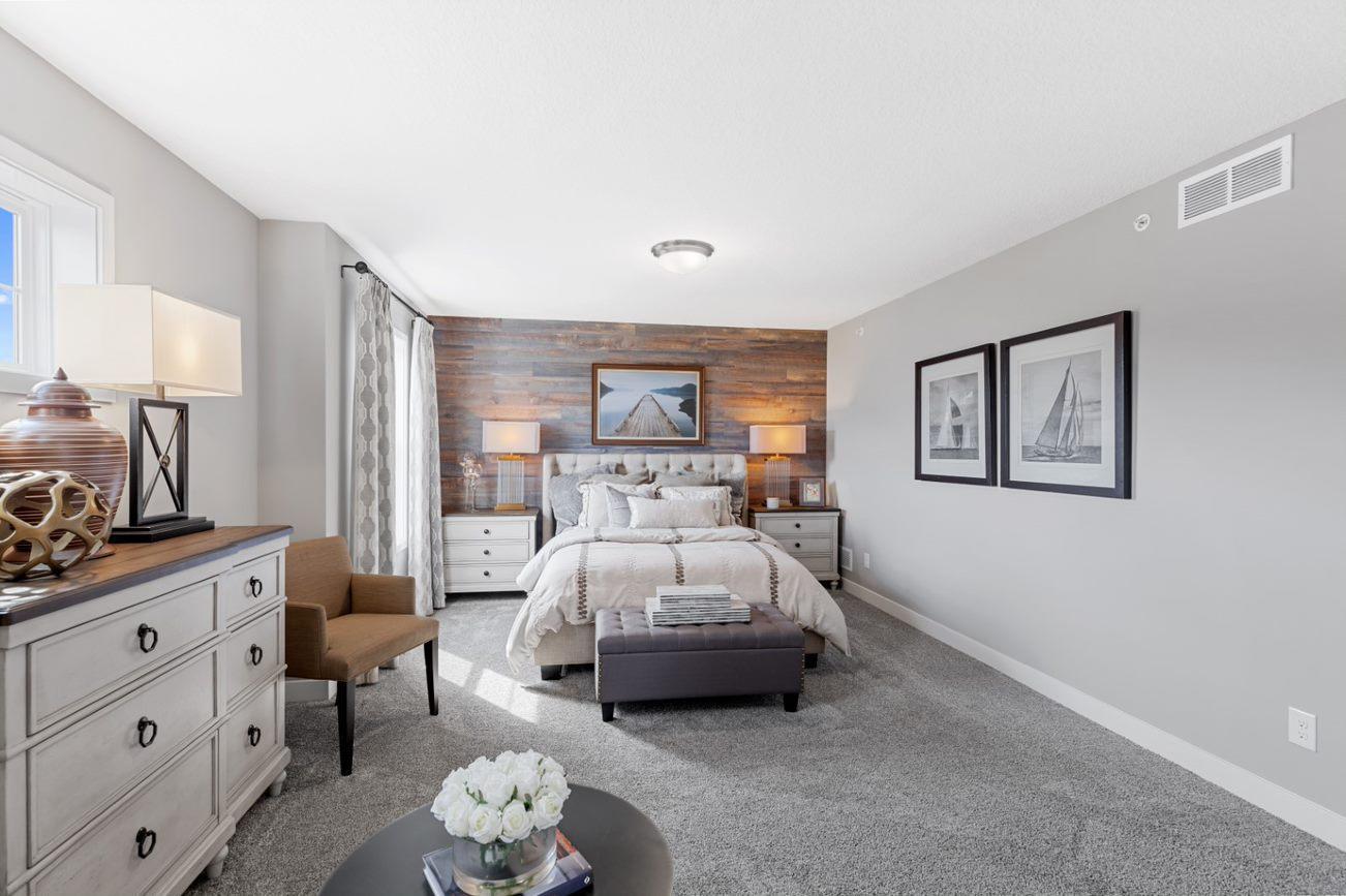 (Photo of a decorated model, actual homes finishes will vary) Spacious, imaginative and modern would best describe the owner's suite.