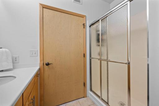 Primary en-suite bath with glass-enclosed shower