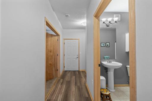 Entry hallway with new LVP flooring and access to a full bath