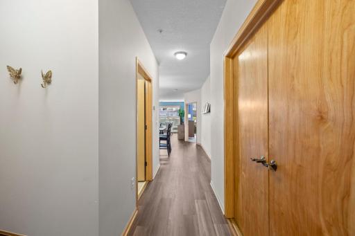 Foyer with new LVP flooring and closet storage, opening to the kitchen and living area