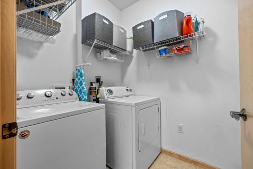 Full-size in-unit laundry room with built-in shelving
