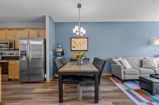 Dining space set beside the kitchen's stainless appliances