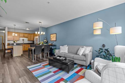 Open-concept living, dining, and kitchen space with new LVP flooring throughout