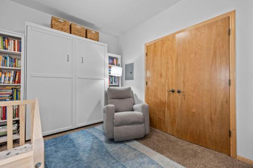 Second bedroom with closet storage and Murphy bed for flexible guest or office use