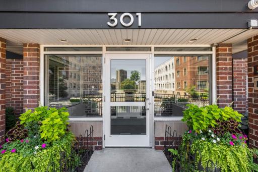 Charming entrance at 301 Oak Grove, flanked by flowering planters
