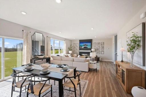Wonderful open concept that flows from the kitchen through to the living room. Luxury vinyl plank flooring extends into living room. Photo of model home, colors and finishes may vary.
