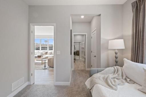 This home offers a main floor ensuite bedroom with a private three quarter bathroom. Photo of model home, colors and finishes may vary.