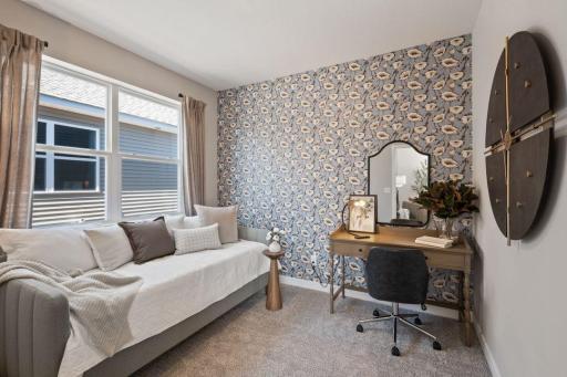 The en-suite bedroom on the main level of the home. Photo of model home, colors and finishes may vary.