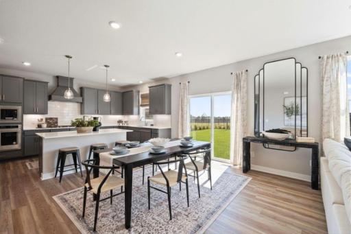 The sliding door offers amazing natural light on the main level of the home. Photo of model home, colors and finishes may vary.