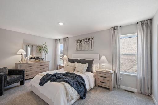 The second of four upper level bedrooms is a junior suite. Photo of model, colors and finishes may vary.
