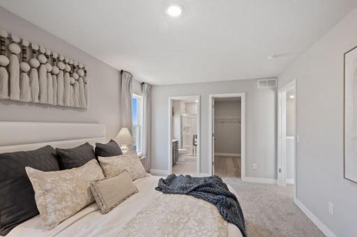 The junior suite on the upper level is a great feature of this home with a private bathroom and walk-in closet. Photo of model, colors and finishes may vary.
