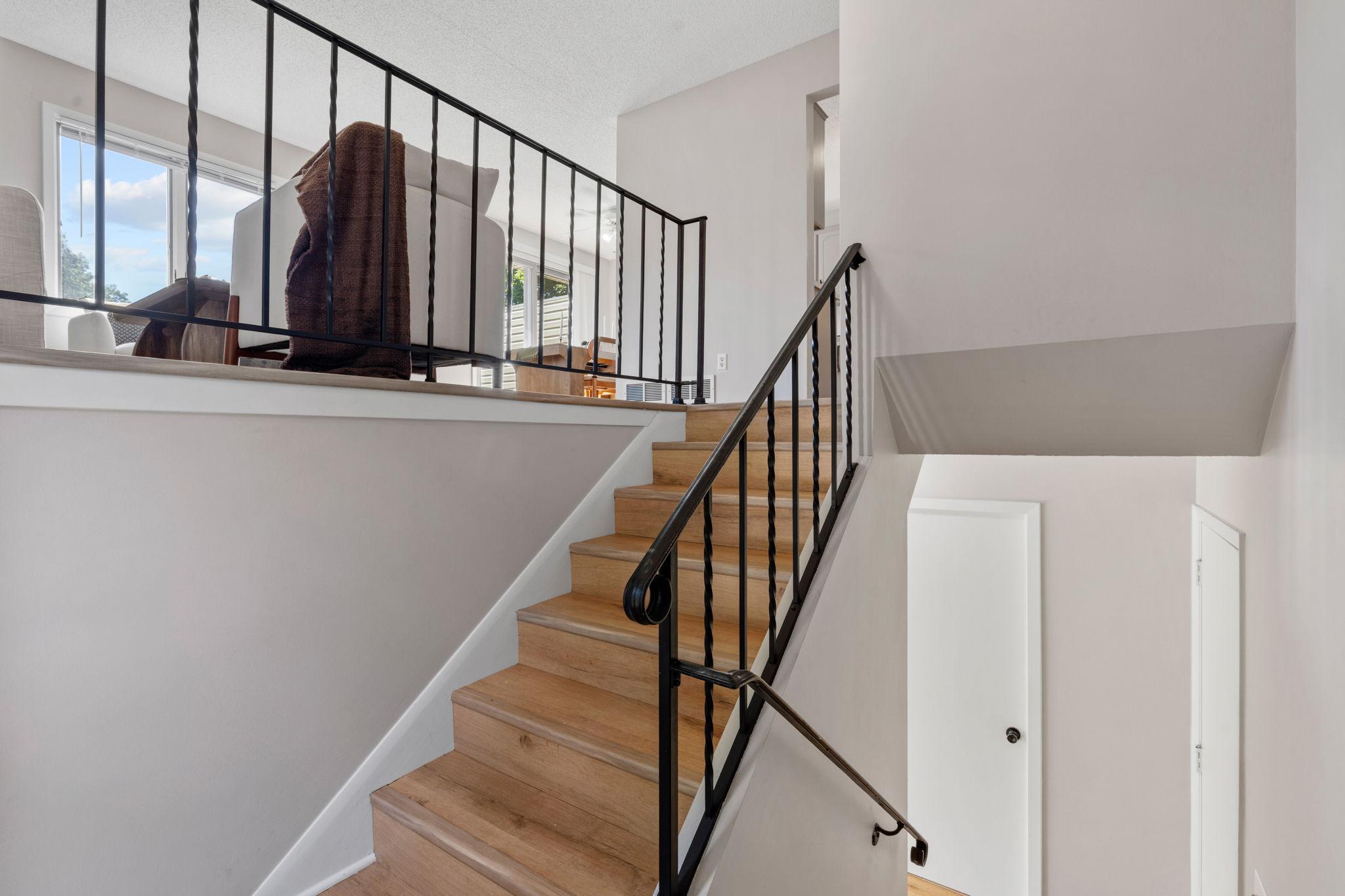 Foyer and staircase showcasing the open entry and updated finishes.