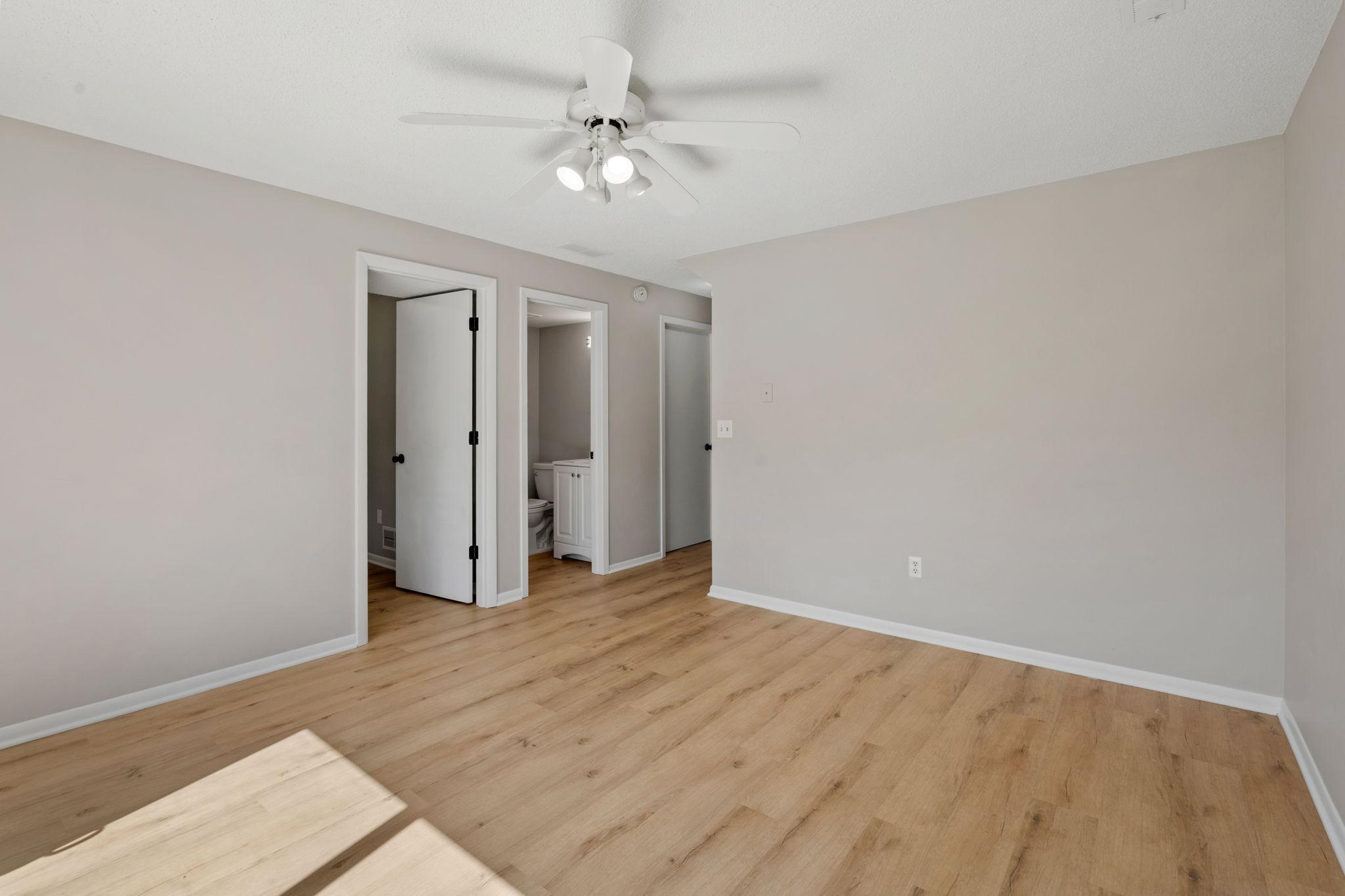 Additional view of the primary bedroom with fresh, neutral finishes.