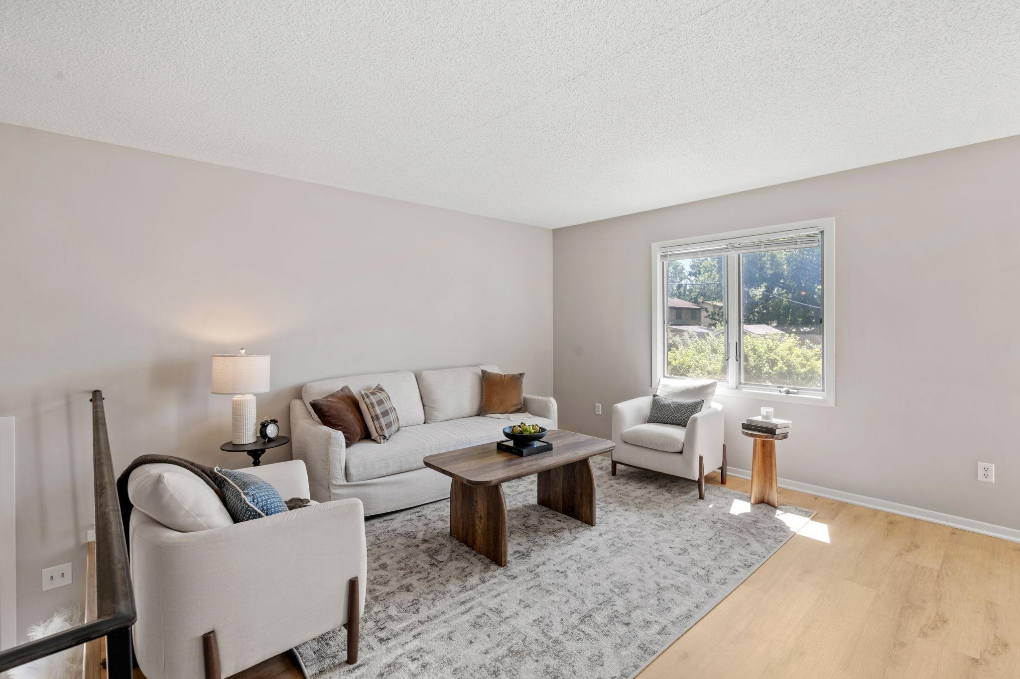 Living room with updated white oak flooring and abundant natural light.