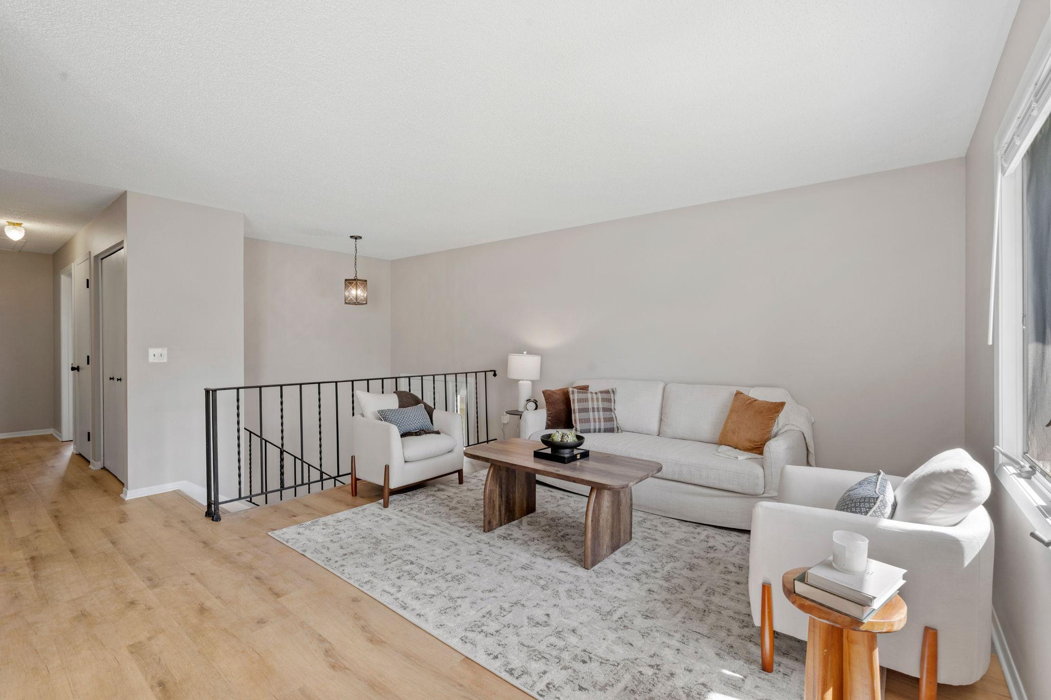 Alternate view of the living room featuring fresh paint and a bright, open layout.