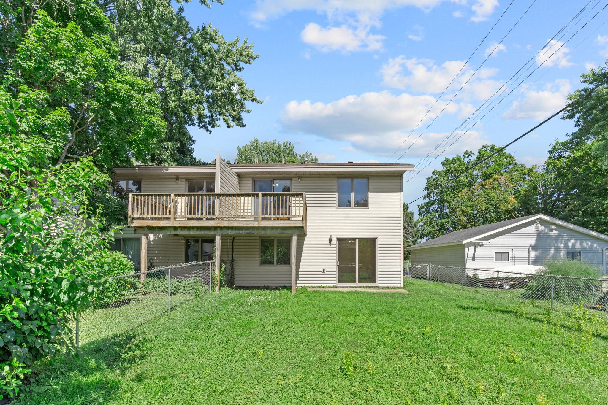 Rear exterior with backyard.