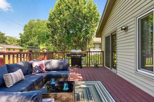 Step onto the spacious deck, perfect for outdoor dining, with a dedicated gas line for your grill, making entertaining easy while you relax and enjoy the backyard views