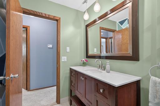 A second view highlights the spacious vanity and thoughtful updates that make this bathroom both functional and trendy.