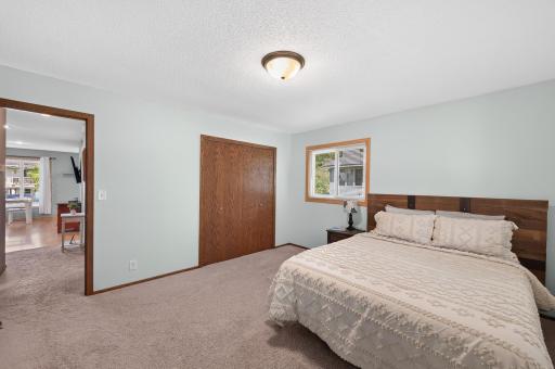 Another view of the primary bedroom with a large closet and newer windows.