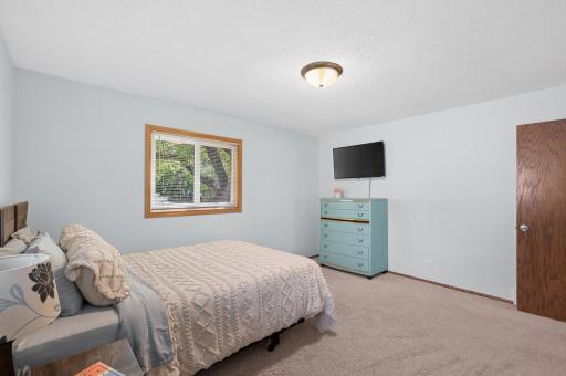 Another view of this generously sized bedroom, showcasing its flexible layout and bright, inviting feel