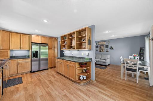 Under-cabinet lighting and a dedicated counter area create the perfect space for a coffee station, beverage bar, or serving area.