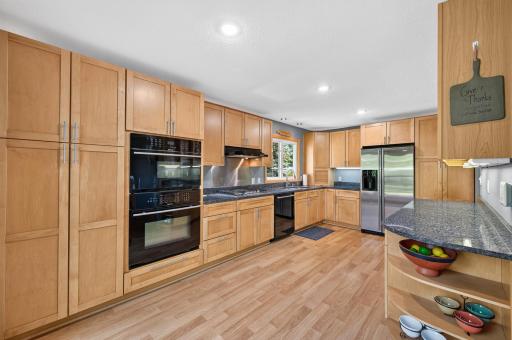 The kitchen offers abundant cabinet space and plenty of room for meal prep.