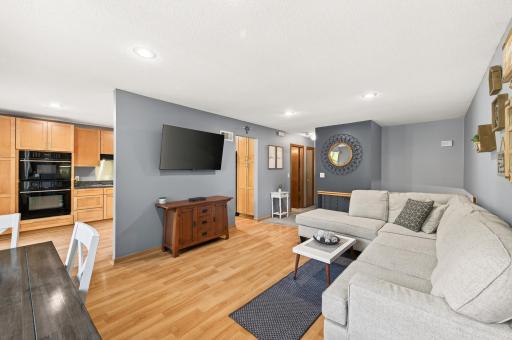 The open layout creates an easy flow between the living room, dining area, and kitchen.