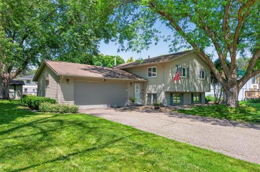 A long driveway and attached two-car garage offer plenty of parking and convenience.