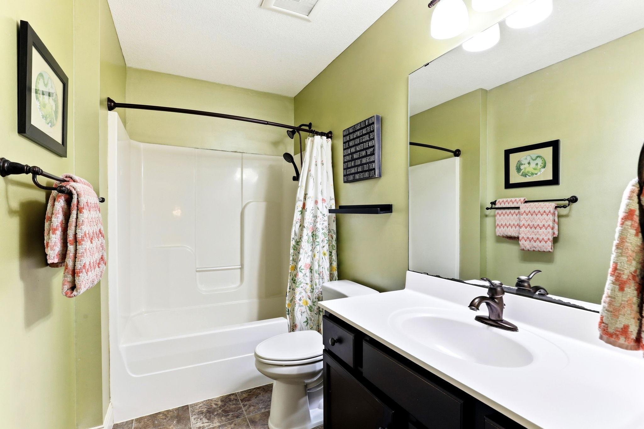 Full upper-level guest bath featuring vanity with storage, shower/tub combination, and oil-rubbed bronze fixtures.