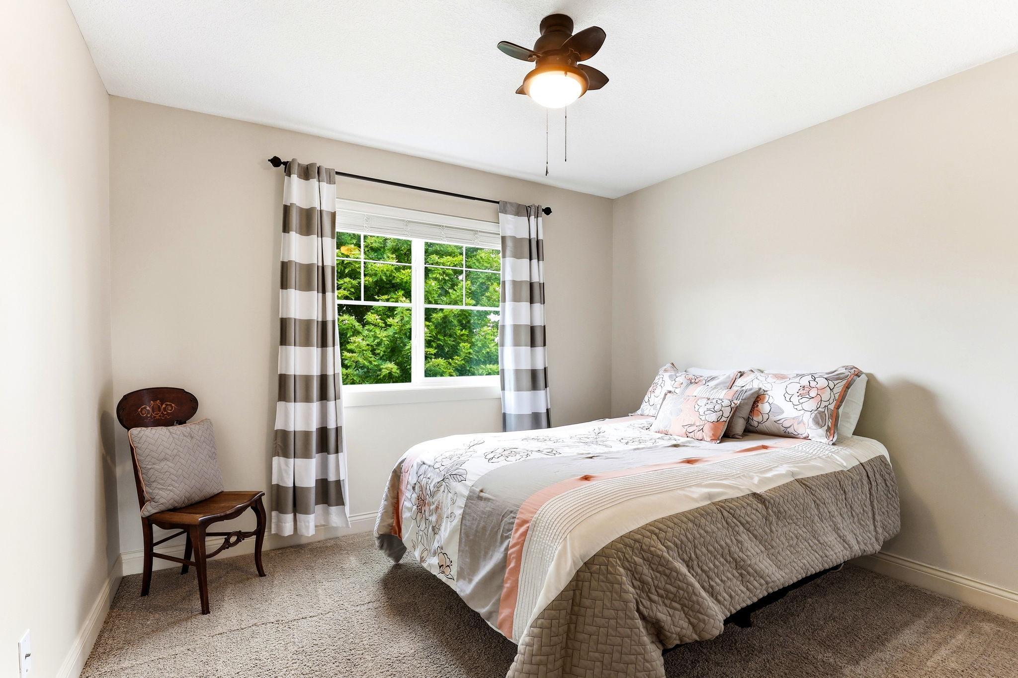 Versatile third bedroom with ceiling fan—ideal for a dedicated home office, nursery, or craft room.