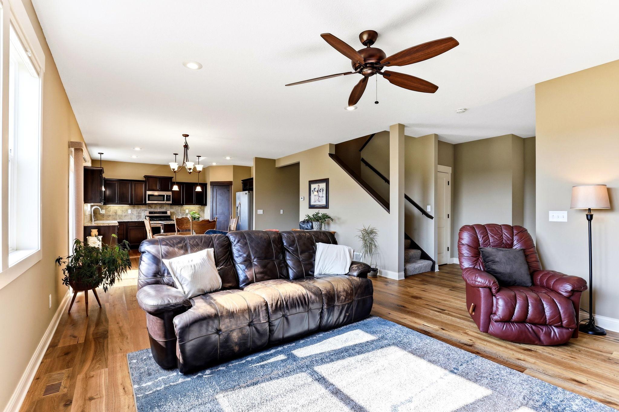 Open-concept main level highlighting the new hardwood floors (2021) and direct access to the upstairs loft and bedrooms.