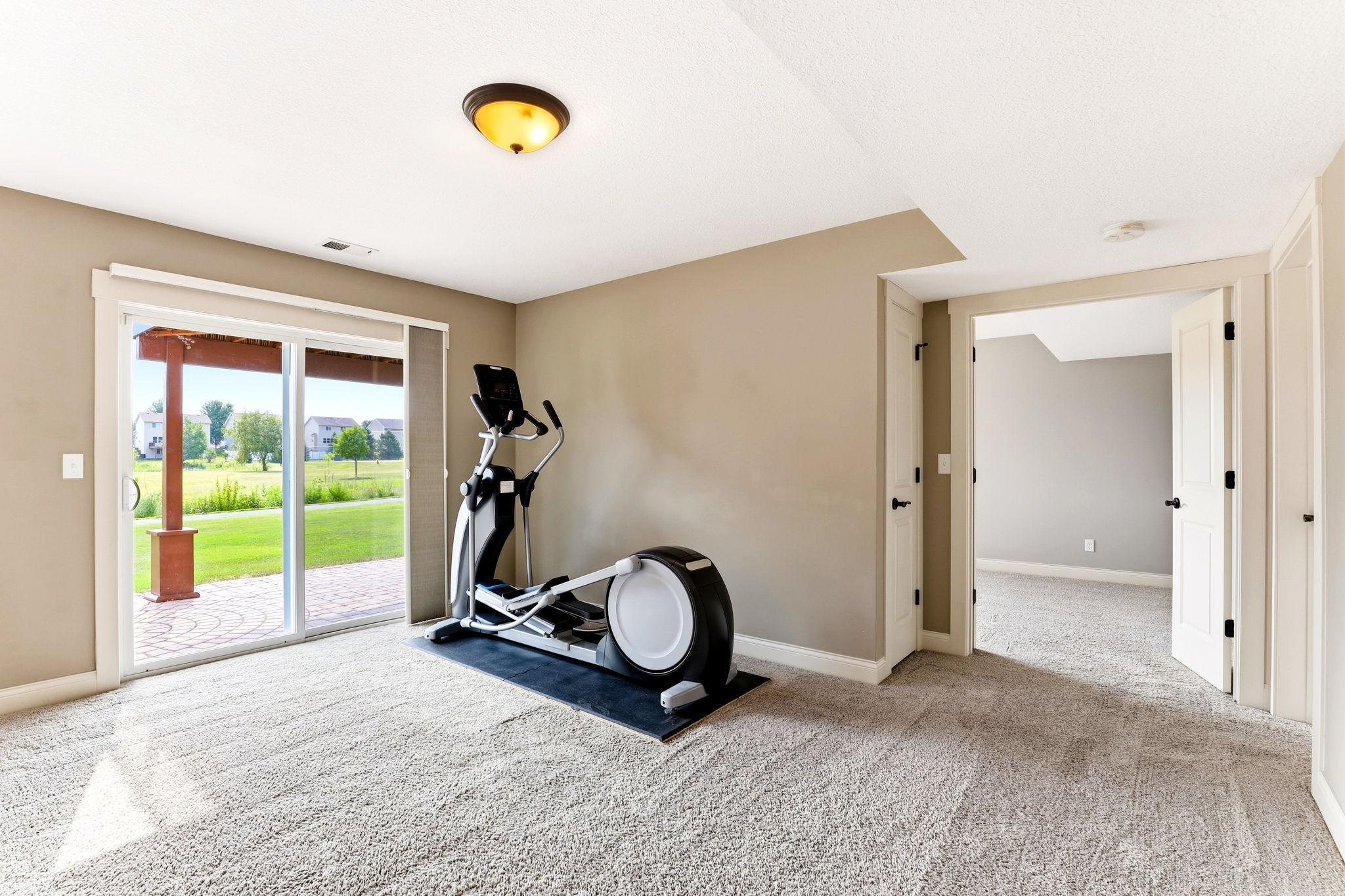 Walkout basement with sliding glass doors leading directly to the covered paver patio.
