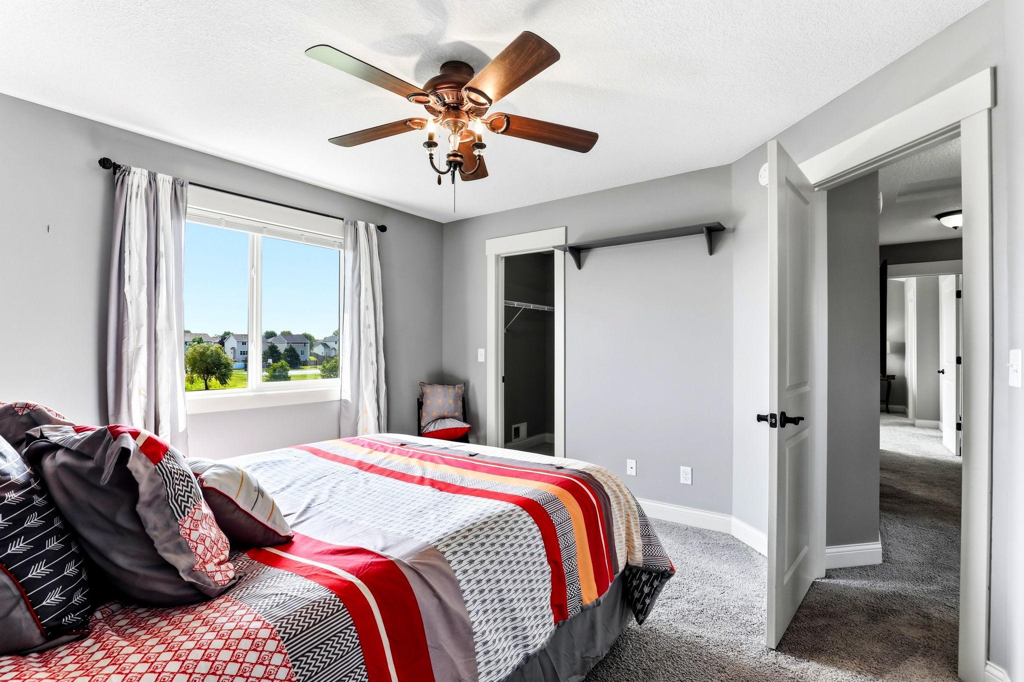 Second bedroom features neutral paint and dedicated walk-in closet.