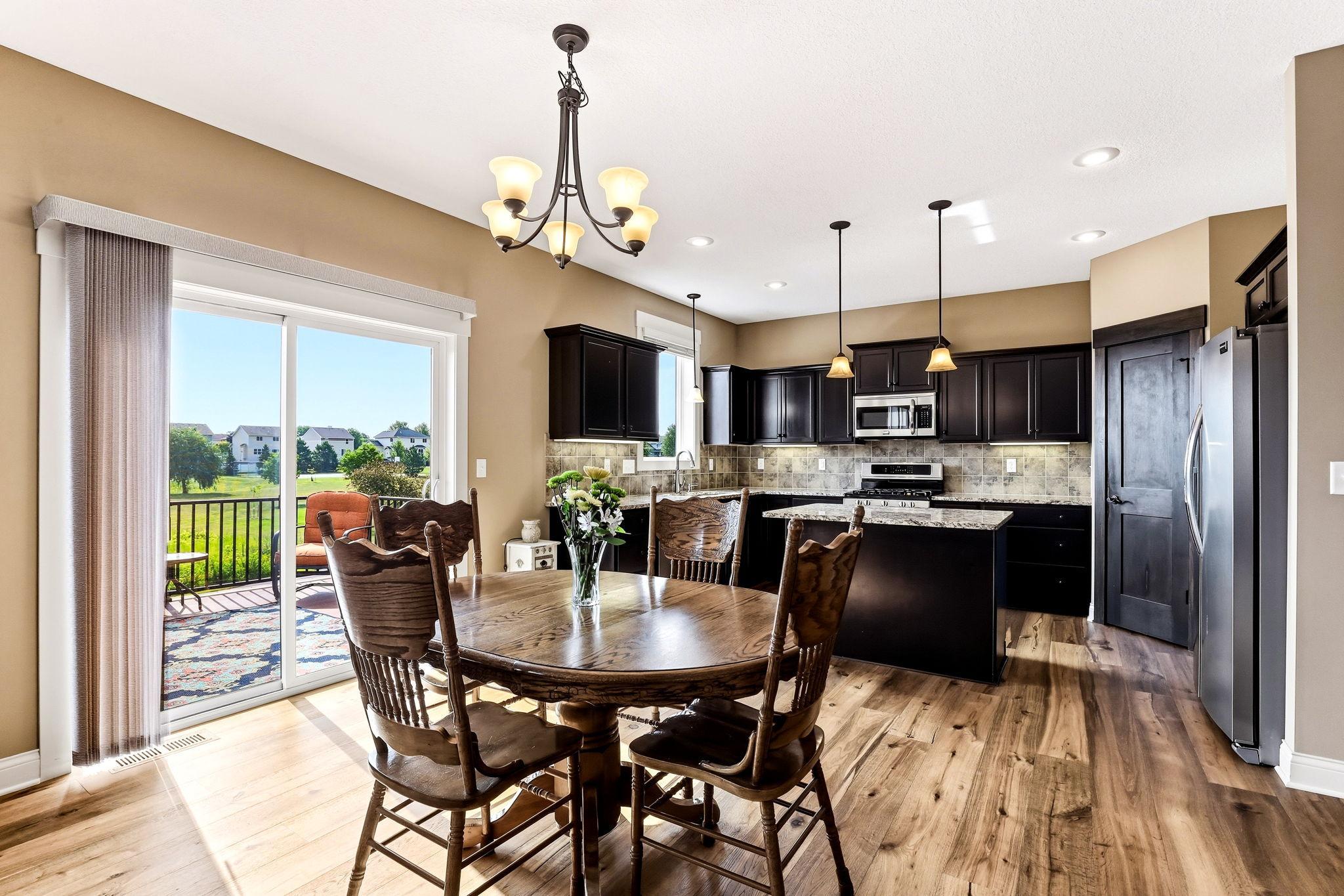 Modern open-concept floor plan seamlessly connects the spacious dining area, gourmet kitchen, and adjacent living space.