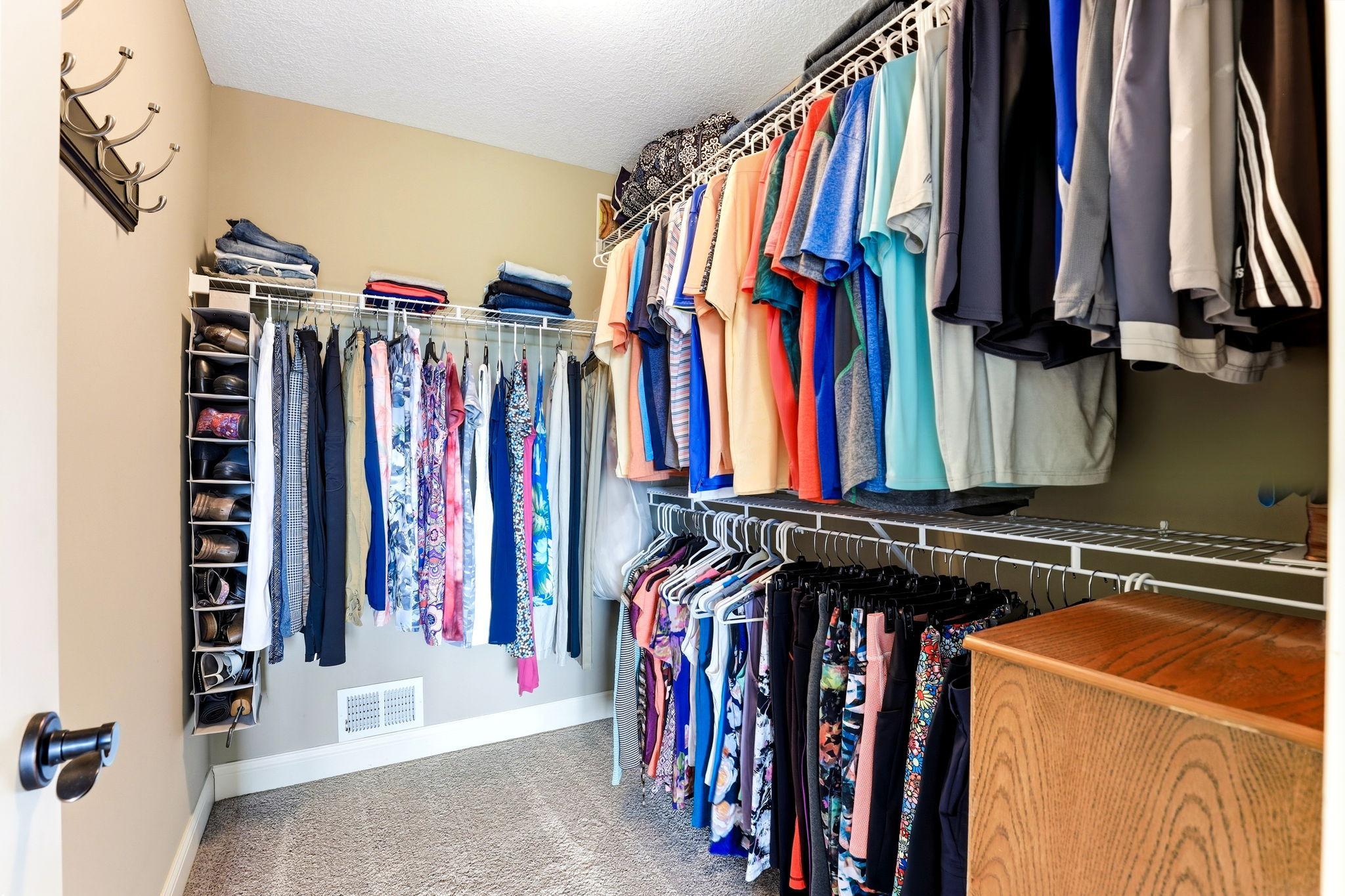 Primary bedroom walk-in closet with built-in wire shelving for optimal organization.