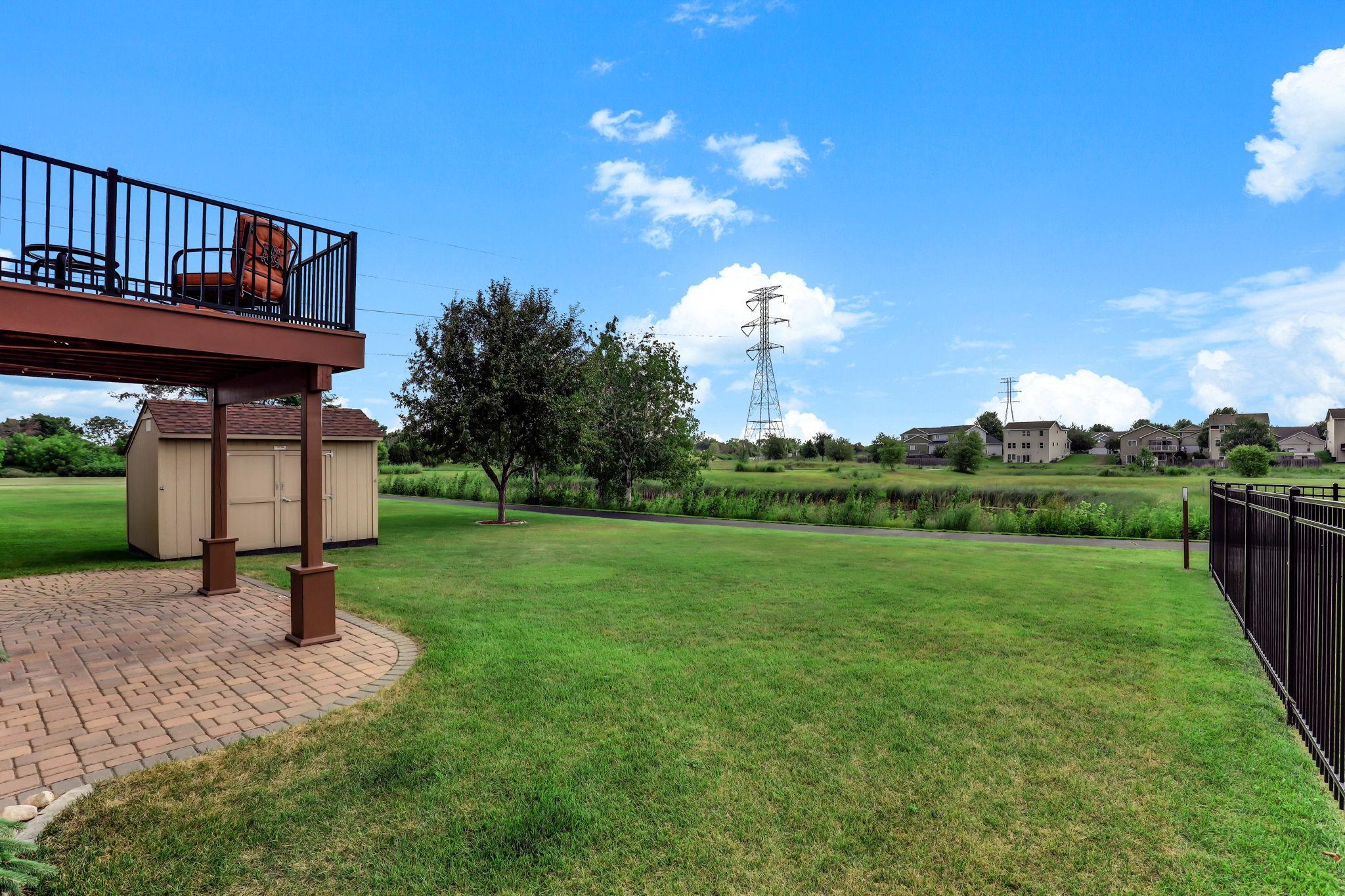 Spacious green yard equipped with Rachio smart irrigation and an invisible underground dog fence.