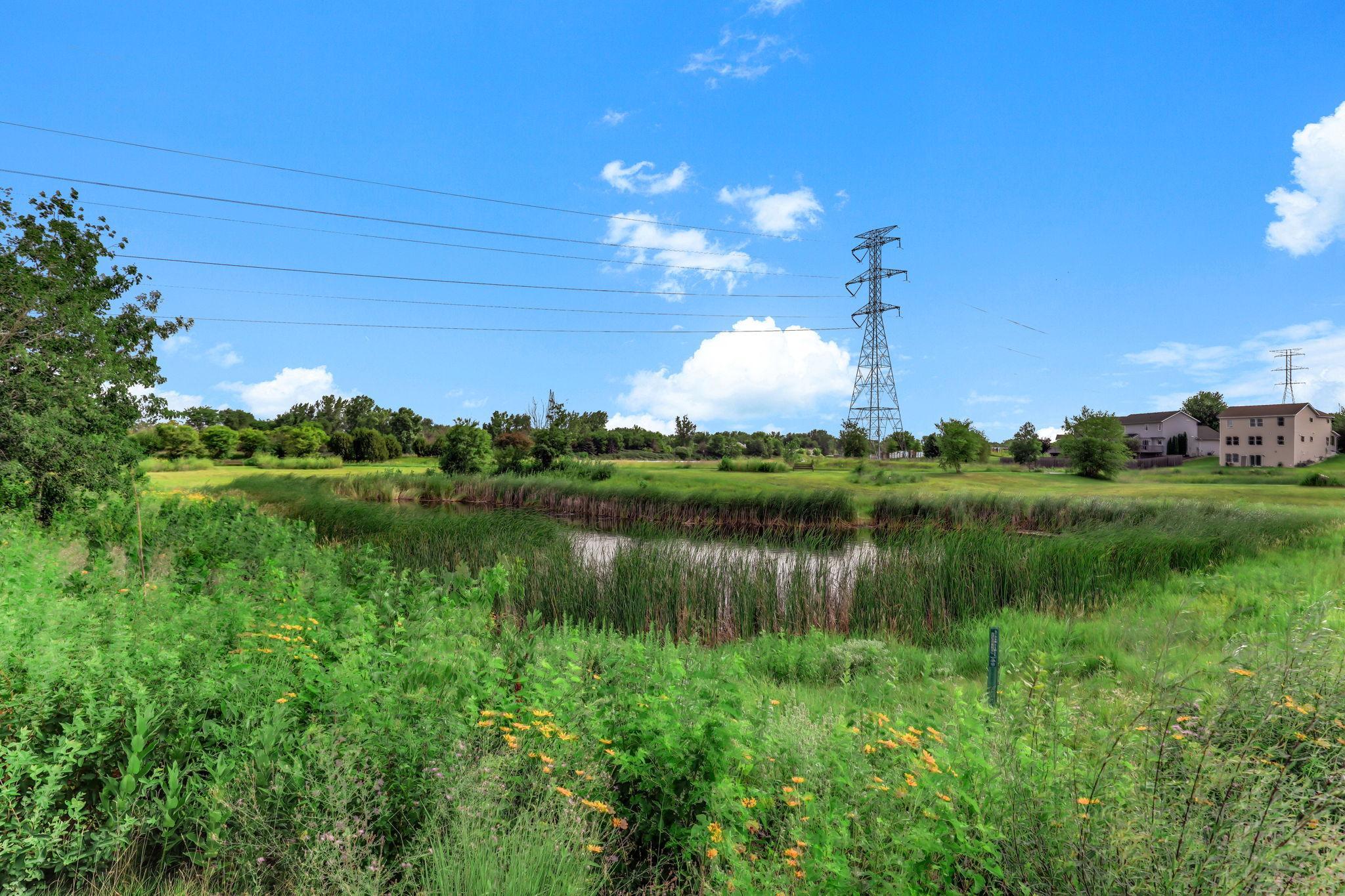Picturesque pond view creating a tranquil, green backdrop for outdoor enjoyment.
