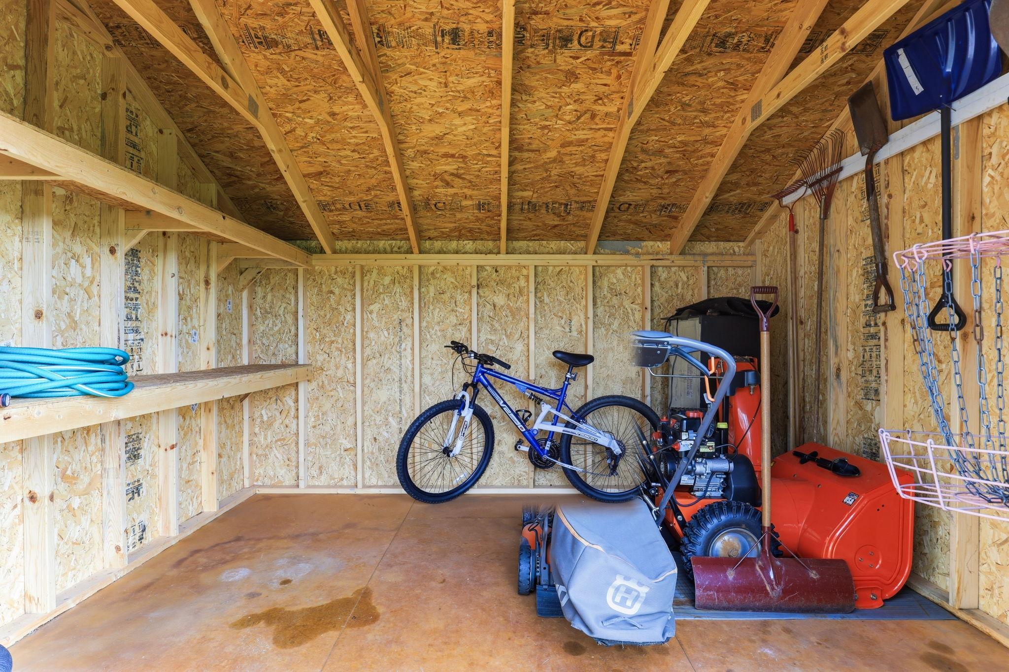 Tuff shed interior with custom built-in shelving, maximizing storage space for tools and gear