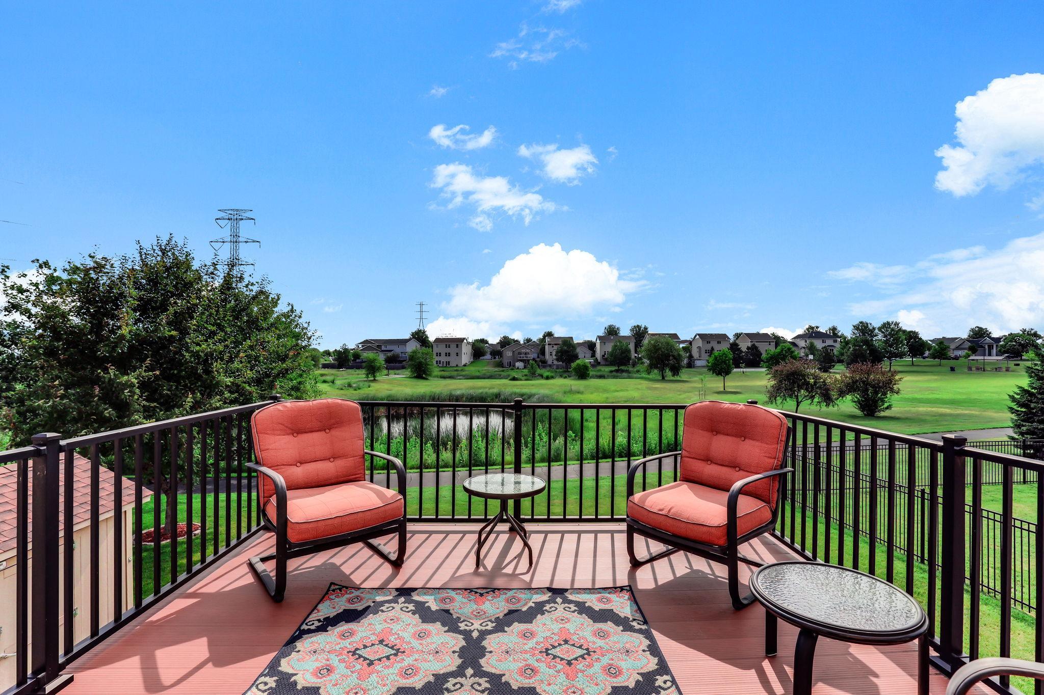 Maintenance-free deck off the dining room offering panoramic views of lush green space and pond.