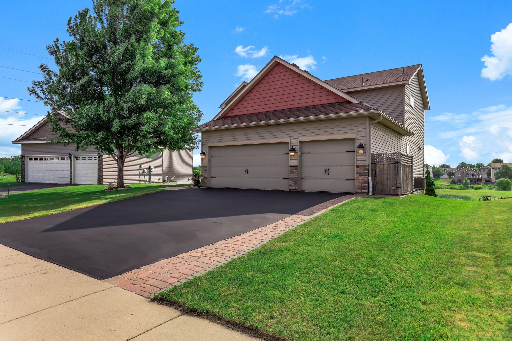 Insulated 3-car garage with Wi-Fi opener, 50-amp power hookup, and built-in overhead storage racks.