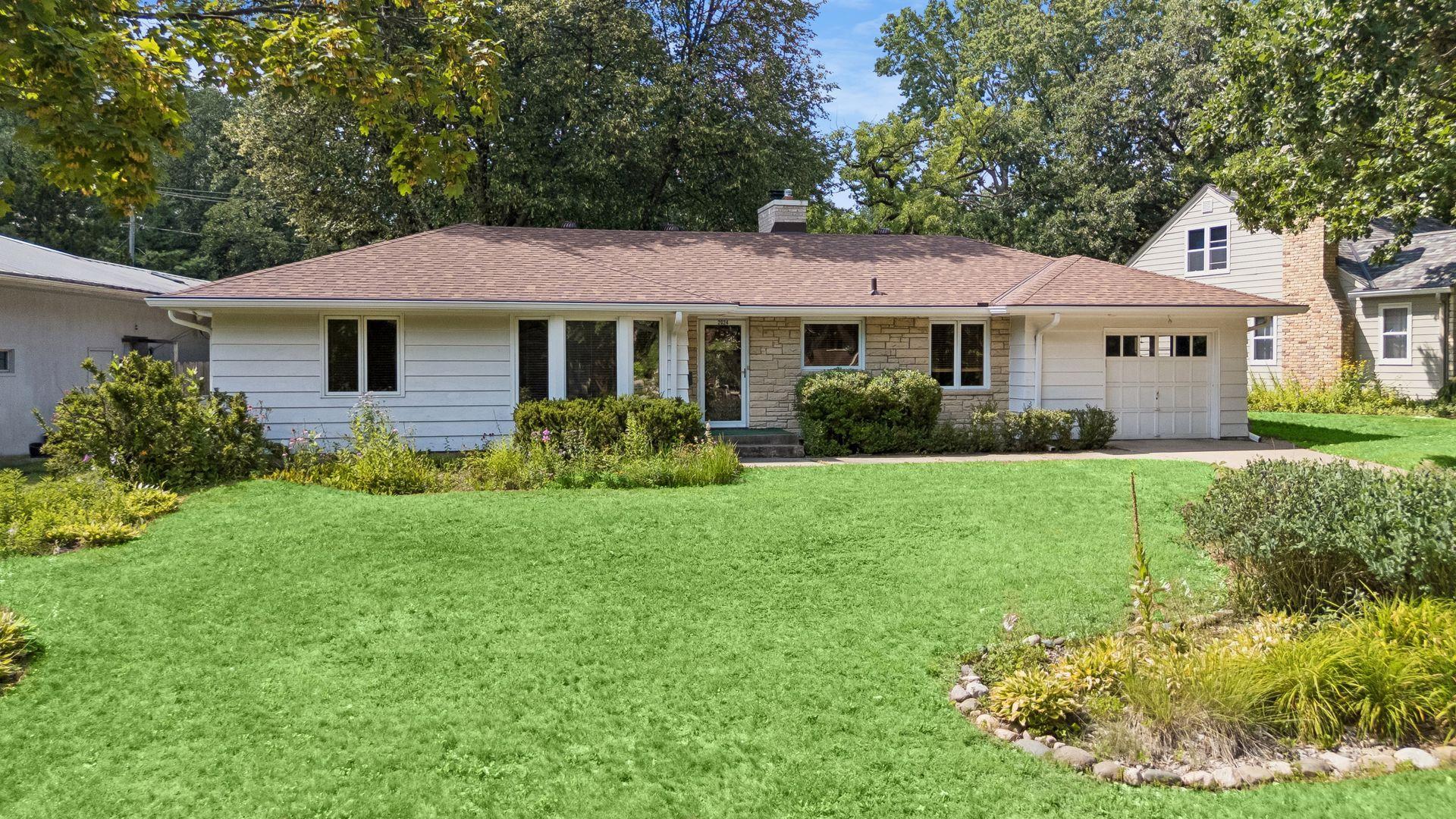 Established perennial garden beds frame the home, while an in-ground sprinkler system helps keep the landscape looking its best.