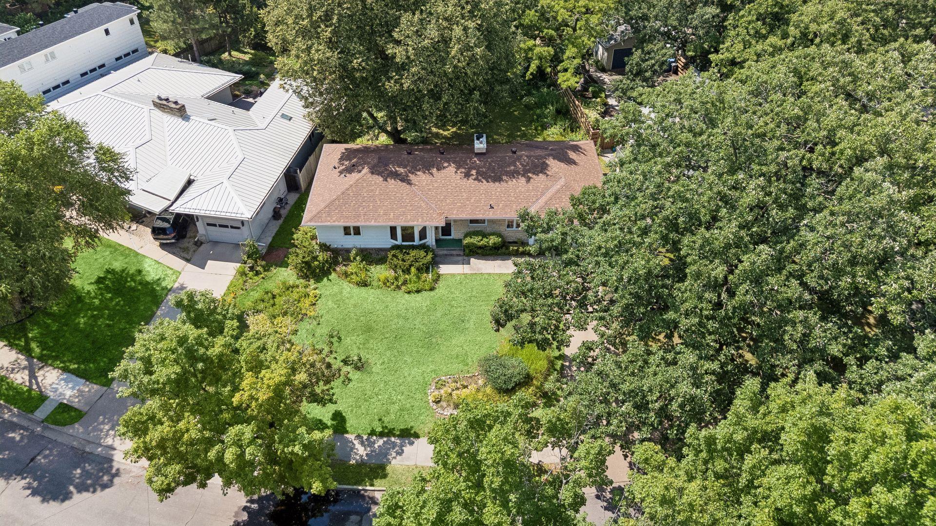 Situated on a beautifully landscaped quarter-acre lot, this home offers an exceptional location just one block from Cedar Lake.