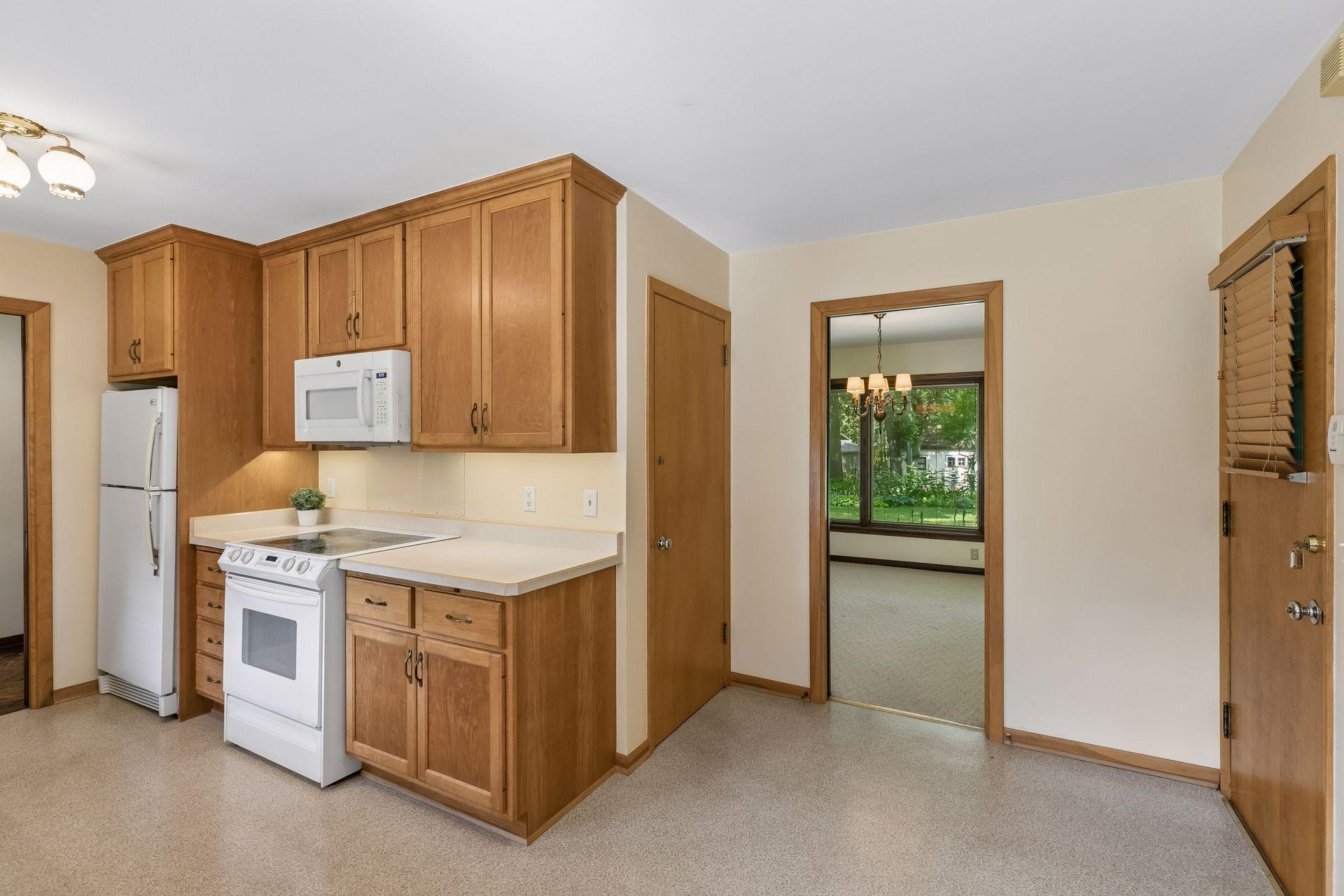 From the screened porch, you'll re-enter the home through the eat-in dining area, where the thoughtful layout provides seamless access to the kitchen, formal dining room and lower level
