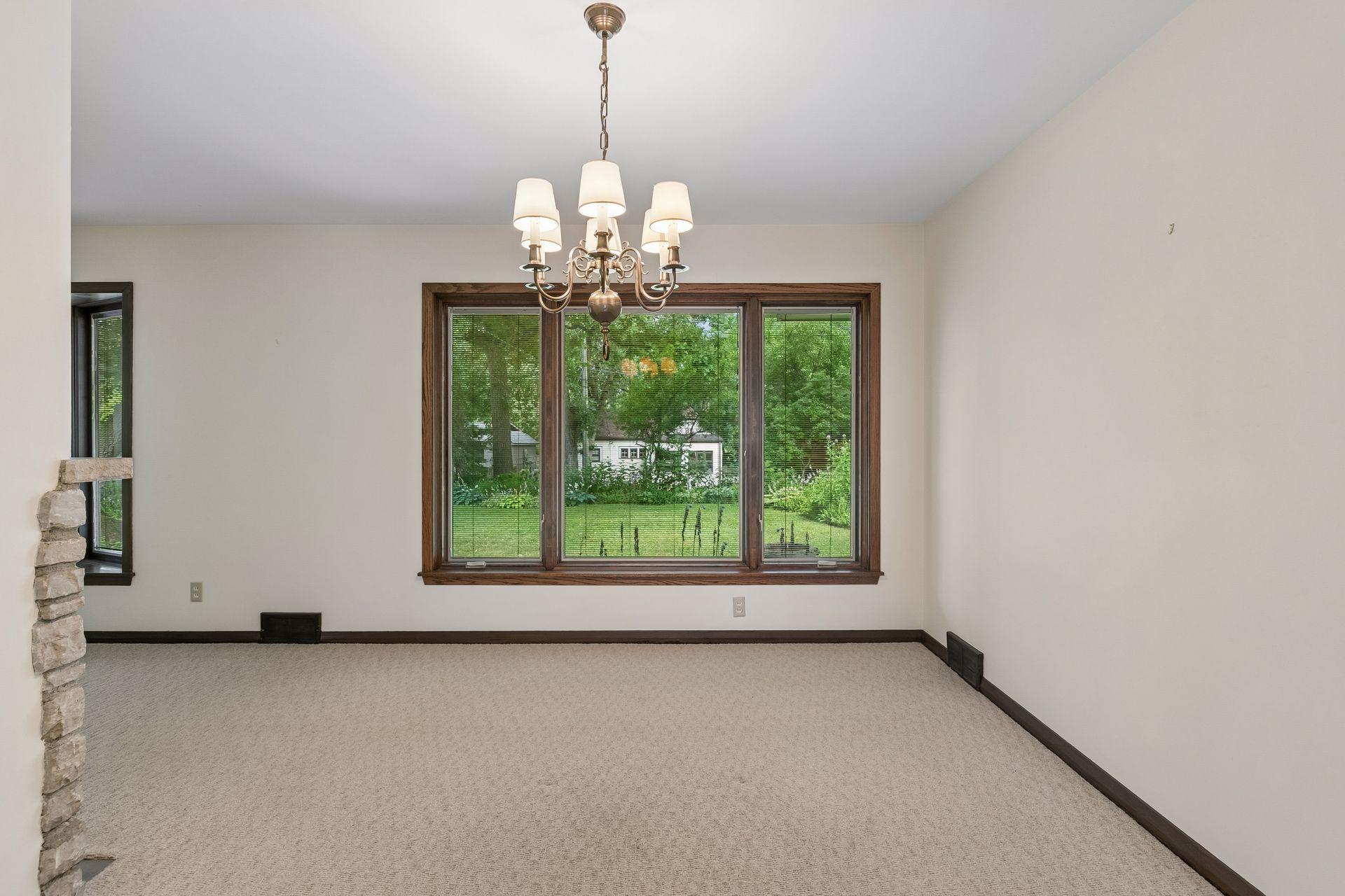 Large picture windows frame beautiful backyard views, filling the living and dining spaces with natural light and a strong connection to the outdoors.