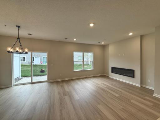 Open concept living with electric fireplace; perfect for chilly winter days and adding ambience for any occasion