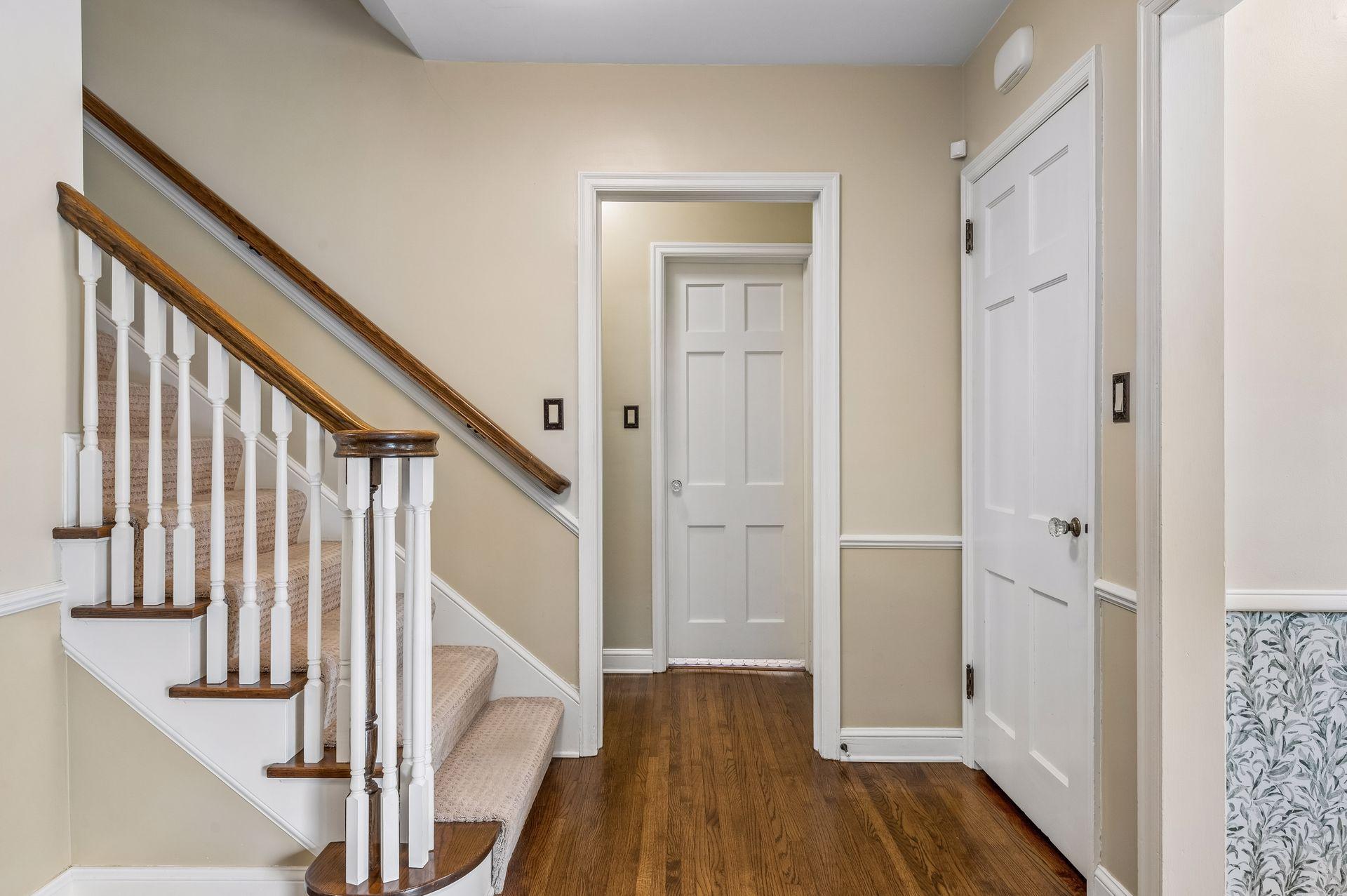 Original spindles and hardwood floors with solid six panel doors add charm to the home
